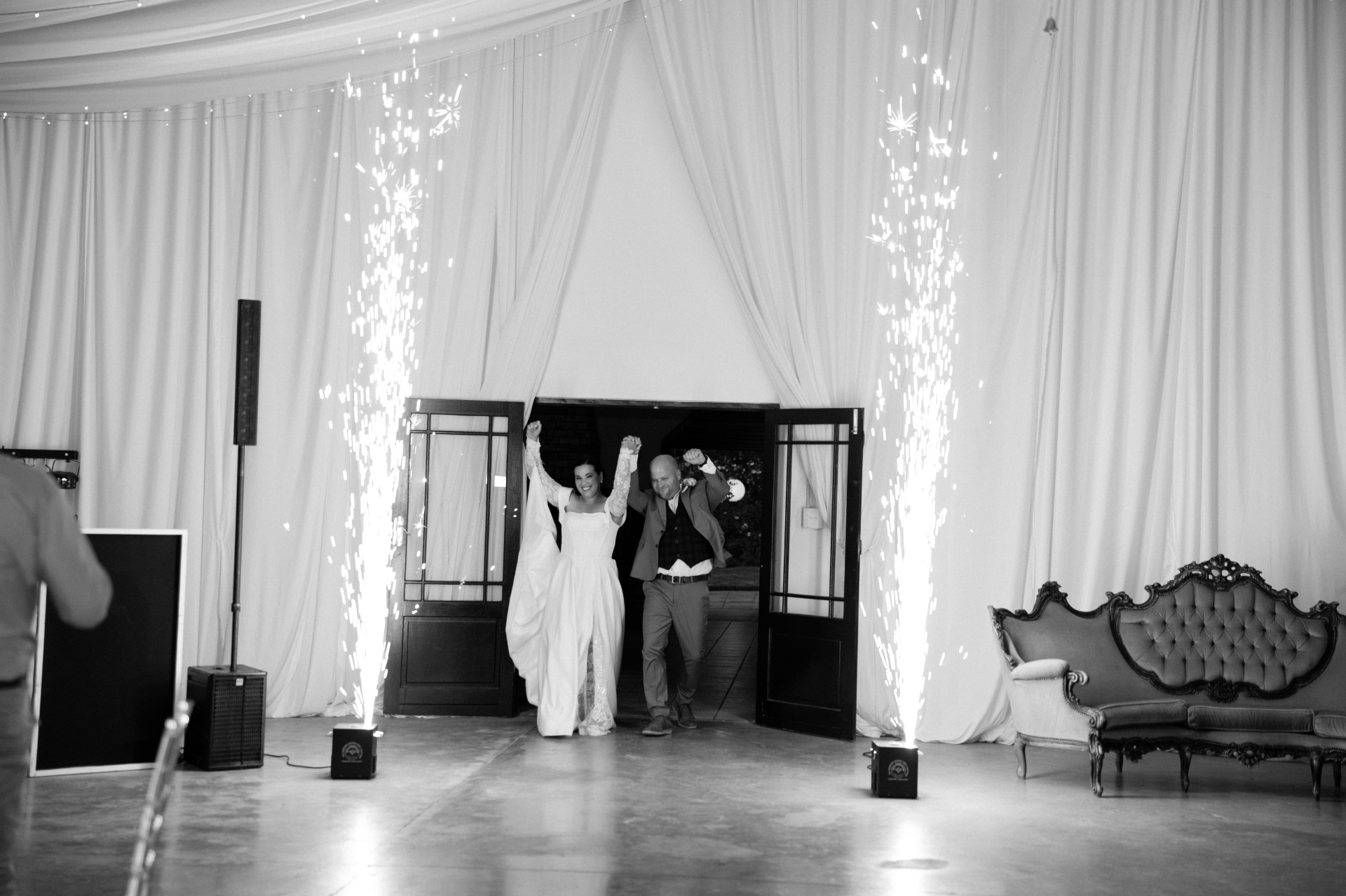 Bride and groom celebrating first dance entrance framed by Cloud Nine Effects cold spark fountains