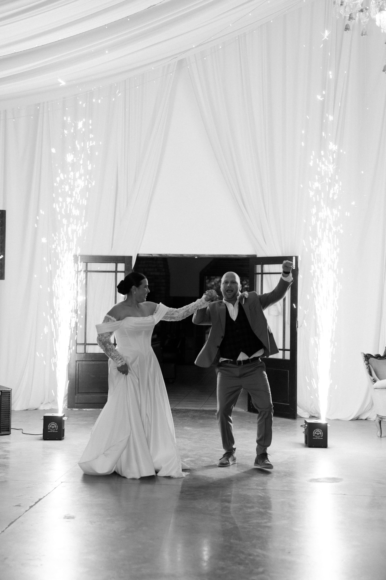 Cold spark fountains rising behind a wedding couple on the dance floor